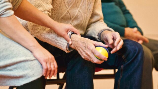 elderly man holding a ball